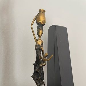 Sculpture of a woman carrying child and bucket
